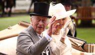 Britain's King Charles III (L) and Britain's Queen Camilla (R) arrive in the parade ring in a horse-drawn carriage in Ascot, west of London, on June 24, 2023. (Photo by Henry Nicholls / AFP)