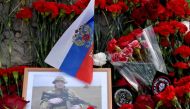 A portrait of Yevgeny Prigozhin is seen amid flowers at a makeshift memorial in front of the Private Military Company (PMC) Wagner Centre in Saint Petersburg, on August 25, 2023. (Photo by Olga Maltseva / AFP)