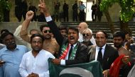 Lawyers and supporters of Pakistan's former Prime Minister Imran Khan, shout slogans as they celebrate outside the Islamabad High Court in Islamabad on August 29, 2023, after suspension of Khan's prison sentence for a graft conviction. (Photo by Farooq Naeem / AFP)