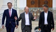 (L-R) German Finance Minister Christian Lindner, German Chancellor Olaf Scholz and German Minister of Economics and Climate Protection Robert Habeck arrive to address a press conference after the second day of a retreat meeting of the German cabinet at Meseberg Palace on August 30, 2023 in Meseberg, north of Berlin, eastern Germany. (Photo by Tobias SCHWARZ / AFP)
