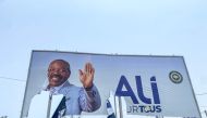 A general view of a torn campaign billboard of ousted Gabon President Ali Bongo Ondimba in Libreville on August 31, 2023.  (Photo by AFP)
