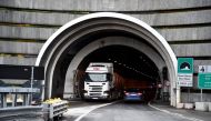 A truck gets out of the tunnel of the Mont-Blanc from Italy as a car enters on January 12, 2017 in Chamonix Mont-Blanc during the presentation of the new computerized safety control system of the Mont Blanc Tunnel, southeastern France. Photo by JEAN-PIERRE CLATOT / AFP
