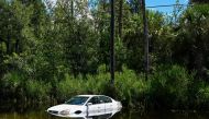 A car is seen downed on the side of a road in Crystal River, Florida on August 31, 2023, after Hurricane Idalia made landfall. Idalia barreled into the northwest Florida coast as a powerful Category 3 hurricane on Wednesday morning, the US National Hurricane Center said. (Photo by CHANDAN KHANNA / AFP)

