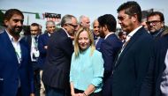 Italian Prime Minister Giorgia Meloni (centre) looks on prior to the start of the Italian Formula One Grand Prix race at Autodromo Nazionale Monza circuit, in Monza on September 3, 2023. (Photo by Marco Bertorello / AFP)