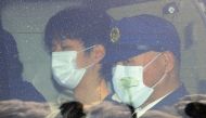 A man (L), whom local media have named as 24-year-old Ryuji Kimura, who is believed to have thrown an explosive toward Japan's Prime Minister Fumio Kishida, leaves Wakayama Nishi Police Station in Wakayama on April 17, 2023. Photo by JIJI Press / AFP
