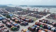 In this photo taken on August 6, 2023 a truck drives between containers at Nanjing port in Nanjing, in China痴 eastern Jiangsu Province. Photo by STRINGER / AFP