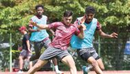 Qatar's Ahmed Al Rawi (left) trains with a teammate.