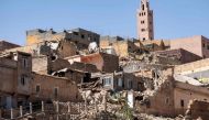 The minaret of a mosque stands behind damaged or destroyed houses following an earthquake in Moulay Brahim, Al-Haouz province, on September 9, 2023. Photo by FADEL SENNA / AFP
