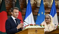 France's President Emmanuel Macron (L) speaks as Bangladesh's Prime Minister Sheikh Hasina looks on during the ceremony of signing bilateral agreements at the Prime Minister's office in Dhaka on September 11, 2023. (Photo by Munir uz zaman / AFP)