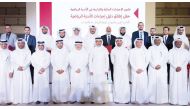 Minister of Sports and Youth H E Salah bin Ghanem Al Ali along with officials poses for a photo after the launch of Sports Clubs Procedures Guide in a ceremony at Al Arabi Sports Club yesterday.    