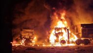 This handout photograph taken and released on September 13, 2023 by the press center of the Defense Forces of Southern Ukraine shows burning trucks following Russian drone attacks in Odesa region, amid Russia's military invasion on Ukraine. (Photo by Handout / press center of Defense Forces of the Southern Ukraine / AFP) 