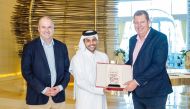 Qatar Cricket Association President Sheikh Abdulaziz Saoud Al Thani presents a memento to ICC Chairman Greg Barclay as ICC CEO Geoffrey Allardice (left) looks on.