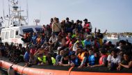 Migrants arrive in the harbour of Italian island of Lampedusa, on September 18, 2023. (Photo by Zakaria ABDELKAFI / AFP)

