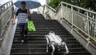 This picture taken on September 22, 2023, shows a demonstration of DEEP Robotics' X30 robot dog walking down steps at the 2022 Asian Games host city Hangzhou. (Photo by Philip Fong / AFP)