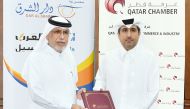 QC General Manager and Chairman of the Exhibition’s Technical Committee Saleh bin Hamad Al Sharqi and Editor-in-Chief Al Sharq Jaber Al Harami exchanging document after signing the agreement. 