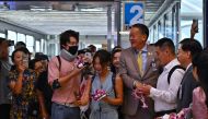 Thailand's Prime Minister Srettha Thavisin (4th R) greets Chinese tourists as they arrive at Suvarnabhumi International Airport in Bangkok on September 25, 2023. (Photo by Lillian Suwanrumpha / AFP)