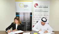 Director of Administrative and Finance Affairs at QC, Hussain Yousef Al Abdulghani and OBG’s Country Director, Fernanda Braz signing the MoU at the 
chamber’s headquarters.