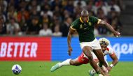 South Africa's wing Makazole Mapimpi (L) fights for the ball with Tonga's wing Fine Inisi (R) during the France 2023 Rugby World Cup Pool B match between South Africa and Tonga at Stade Velodrome in Marseille, south-eastern France, on October 1, 2023. (Photo by CHRISTOPHE SIMON / AFP)
