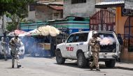Police officers throw tear gas to demonstrators during a protest against insecurity in Carrefour-Feuilles, a district of Port-au-Prince, Haiti, on August 14, 2023. (Photo by Richard Pierrin / AFP)