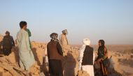 Afghan residents clear debris from a damaged house after earthquake in Sarbuland village of Zendeh Jan district of Herat province on October 7,2023 (Photo by Mohsen Karimi / AFP)