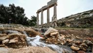 Water flows through the ruins at the site of the ancient Greco-Roman city of Cyrene (Shahhat) in eastern Libya, about 60(37 miles) west of Derna, on September 21,2023, in the aftermath of a devastating flood. (Photo by Ozan Kose / AFP)