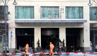 (Files) Workers of the city cleaning department walk past debris covering the street in front of the Radisson Blu hotel after a huge aquarium burst on December 16, 2022 in Berlin. (Photo by John MacDougall / AFP)