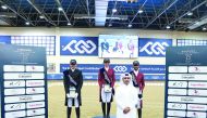 Maryam Ahmed Alsemaitt (centre) poses on the podium along with Saoud Ahmed Al Boinin (left) and Al Jaham Al Kuwari yesterday