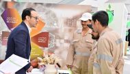 Dr. Ehab Hamed, Family Medicine Consultant and Physician at QU Health Center educating some workers during the event.