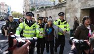 Swedish climate activist Greta Thunberg is arrested by police outside the InterContinental London Park Lane during the 