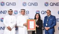 Senior Executive Vice President, QNB Group Projects & General Services Division, Yousef Ali Al Darwish (second left) and other officials with the ISO certification.