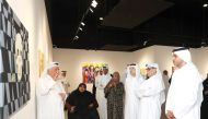 Minister of State and President of the Qatar National Library H E Dr. Hamad bin Abdulaziz Al Kawari (second right) and Saif Saad Al Dosari, Deputy Director-General of Katara and Director of Human Resources (right), along with other artists and officials during the opening of the exhibition.