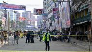 Bangladesh's Criminal Investigation Department (CID) member inspects a protest site after Bangladesh Nationalist party (BNP) activists held a rally amid the ongoing nationwide strike in Dhaka on October 29, 2023.  (Photo by Munir Uz Zaman / AFP)