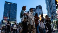 Pedestrians at a busy intersections of Tokyo on October 27, 2023. (Photo by Philip Fong / AFP)
