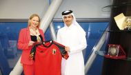 Qatar Football Association President Jassim bin Rashid Al Buenain receives a Belgium team jersey from President of the Royal Belgian Football Association Pascale Van Damme. 