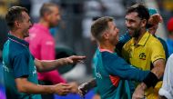 Australia's Glenn Maxwell (R) celebrates with teammates after winning the 2023 ICC Men's Cricket World Cup one-day international (ODI) match between Australia and Afghanistan at the Wankhede Stadium in Mumbai on November 7, 2023. (Photo by INDRANIL MUKHERJEE / AFP)