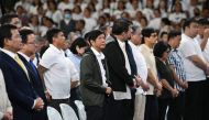 Philippine President Ferdinand Marcos Jr., (C) attends a mass to commemorate the 10th year anniversary of Super Typhoon Haiyan inside a stadium in Tacloban City, Leyte province, central Philippines. (Photo by Ted Aljibe / AFP)