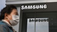 A woman walks past the Samsung logo in front of a Samsung Electronics store in Seoul on October 31, 2023. Photo by Jung Yeon-je / AFP