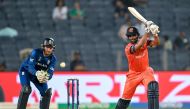 Netherlands' Teja Nidamanuru plays a shot as England's captain Jos Buttler (L) watches during the 2023 ICC Men's Cricket World Cup one-day international (ODI) match between England and Netherlands at the Maharashtra Cricket Association Stadium in Pune on November 8, 2023. (Photo by Punit PARANJPE / AFP)