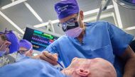 In this May 27, 2023, image released by NYU Langone Health, Dr. Eduardo Rodriguez operates on Aaron James in the first whole-eye and partial face transplant, at NYU Langone Health in New York. (Photo by Joe Carrotta / NYU Langone Health / AFP) 