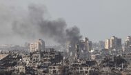 Smoke billowing behind destroyed buildings in the Palestinian enclave during an Israeli strike on November 10, 2023. (Photo by Jack Guez / AFP)
