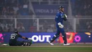 Pakistan's Mohammad Rizwan (L) reacts after a muscle cramp upon his dismissal as England's captain Jos Buttler walks past during the 2023 ICC Men's Cricket World Cup one-day international (ODI) match between England and Pakistan at the Eden Gardens in Kolkata on November 11, 2023. (Photo by Arun SANKAR / AFP)
