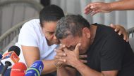 Luis Manuel Diaz, father of Liverpool's forward Luis Diaz, is consoled by his wife Cilenis Marulanda during a press conference at his house in Barrancas, Colombia on November 10, 2023. (Photo by Daniel Munoz / AFP)
