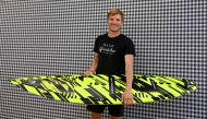 German surfer Sebastian Steudtner poses with his new board at the booth of German car producer Porsche of the IAA Automobile show in Munich, southern Germany, on September 8, 2023. Photo by Christof STACHE / AFP