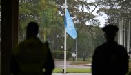 Security officials look on as the United Nations flag flies at half-mast to mourn the lives of UN workers lost during the war in Gaza, at the United Nations Office Nairobi (UNON) in Nairobi on November 13, 2023. Photo by SIMON MAINA / AFP