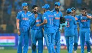India's players celebrate their win at the end of the 2023 ICC Men's Cricket World Cup one-day international (ODI) match against Netherlands at the M. Chinnaswamy Stadium in Bengaluru on November 12, 2023. (Photo by R.Satish Babu / AFP) 