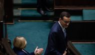 Polish Prime Minister Mateusz Morawiecki (R) attends a session as Poland's new parliament meets for the first time with both the ruling populists and the pro-European opposition bidding to form the next government, on November 13, 2023 in Warsaw. (Photo by Wojtek Radwanski / AFP)
