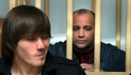(FILES) Suspected Ibragim Makhmudov (L) and Sergei Khadzhikurbanov, former special police unit officer, wait for the beginning of the Moscow Military Court session in Moscow on August 7, 2009. (Photo by ANDREI SMIRNOV / AFP)
