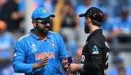 India's captain Rohit Sharma talks with his New Zealand's counterpart Kane Williamson (R) during the toss before the start of the 2023 ICC Men's Cricket World Cup one-day international (ODI) first semi-final match between India and New Zealand in Mumbai on November 15, 2023. (Photo by Punit Paranjpe / AFP)