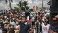 Supporters cheer as members of the collective of opposition candidates march through the streets of Analamahitsy district to protest against the holding of the 2023 Presidential Election, in Antananarivo, on November 14, 2023. 