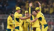 Australia's Travis Head (second right) celebrates with teammates after taking the wicket of South Africa's Heinrich Klaasen during the 2023 ICC Men's Cricket World Cup one-day international (ODI) second semi-final match between Australia and South Africa at the Eden Gardens in Kolkata on November 16, 2023. (Photo by Dibyangshu Sarkar / AFP)